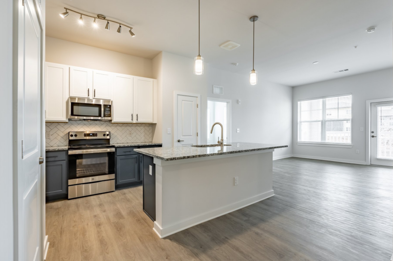 Airy interior kitchen photo with flooring and appliances at the corwyn conyers