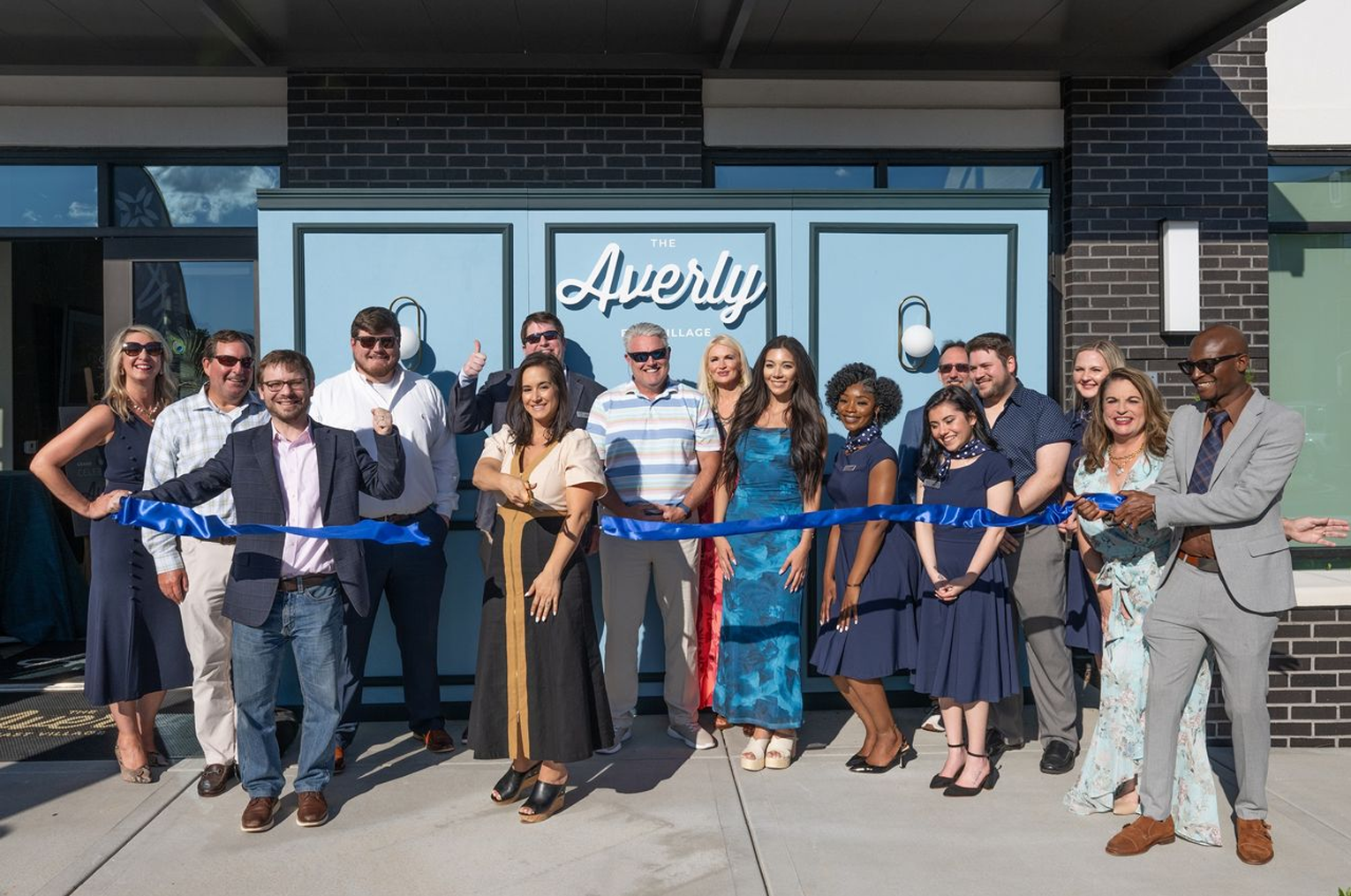 A group of ECI employees cutting the ribbon at The Averly East Village Grand Opening