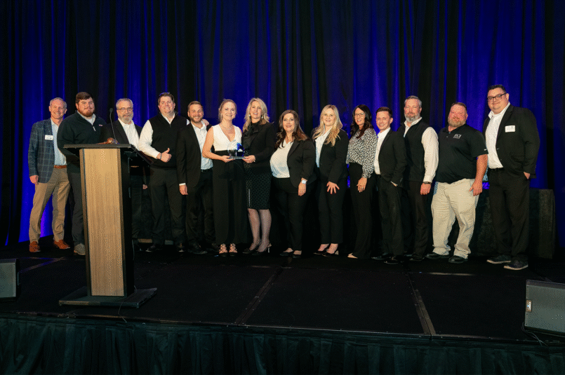 ECI and Atlanta Apartment Association Leadership share the 2nd Place Trophy On Stage