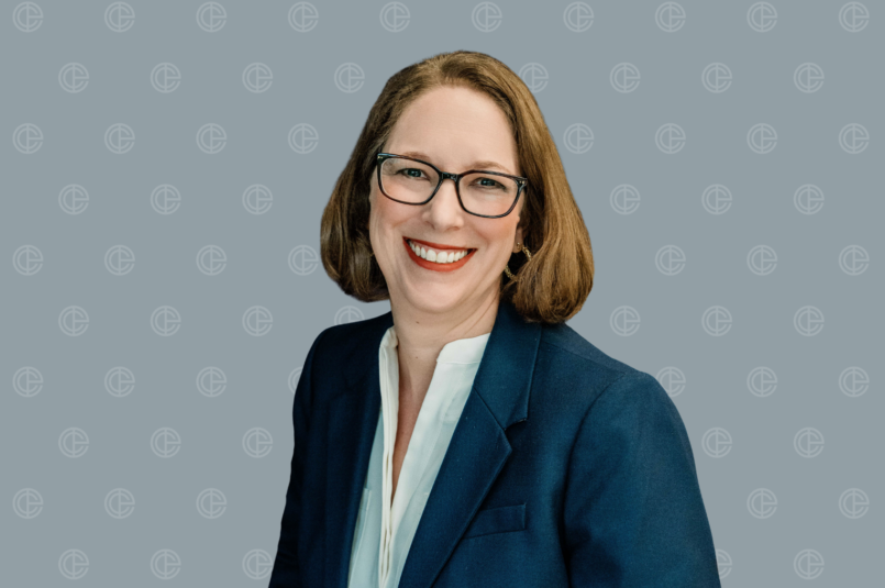 Head Shot of Suzy Alford on Grey ECI branded background.